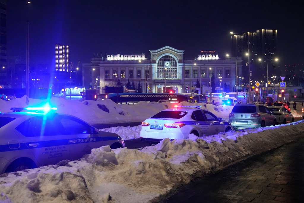Police and emergency services are seen at the scene of an attack on a police patrol near the Savyolovsky Railway Station, in Moscow, Tuesday, Feb. 24, 2026. (AP Photo)