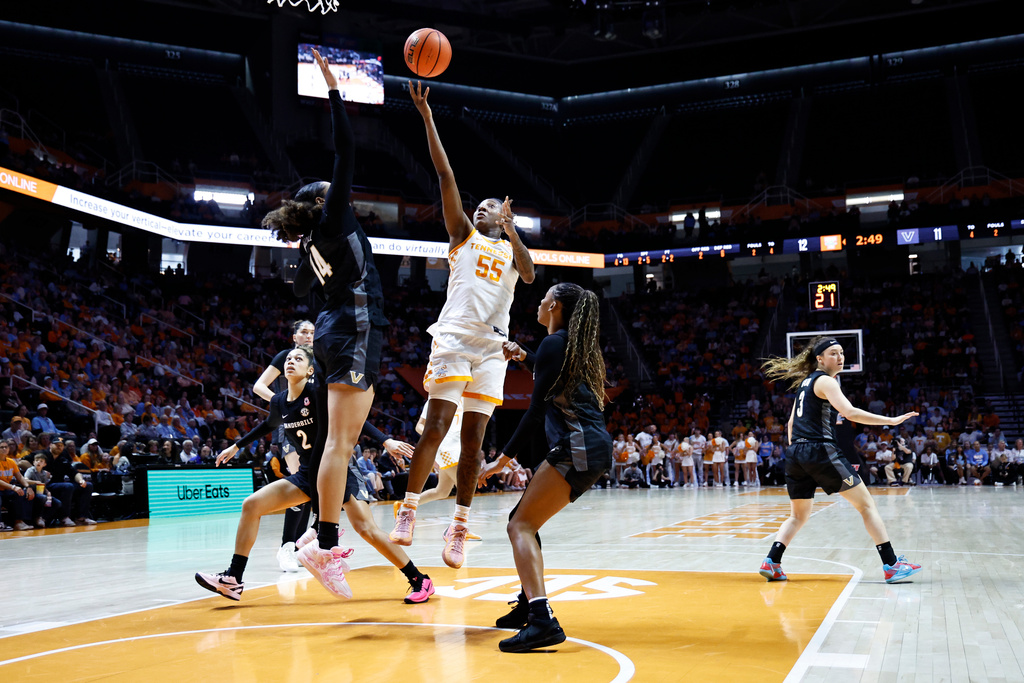 Tennessee guard Talaysia Cooper (55) shoots over Vanderbilt forward Aiyana Mitchell (14) during the first half of an NCAA college basketball game in Knoxville, Tenn., Sunday, March 1, 2026. (AP Photo/Wade Payne)