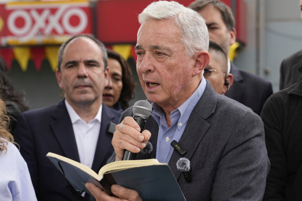 Former Colombian President Alvaro Uribe speaks during a visit the site where presidential hopeful and Sen. Miguel Uribe Turbay was fatally shot during a political rally in Bogota, Colombia, Saturday, Aug. 23, 2025. (AP Photo/Fernando Vergara)