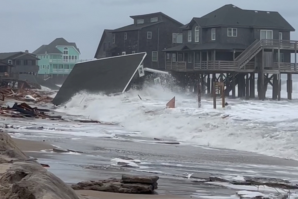 Waves from Hurricanes Humberto and Imelda destroy a home in Buxton, N.C., Tuesday, Sept. 30, 2025. (Heather Jennette via AP)