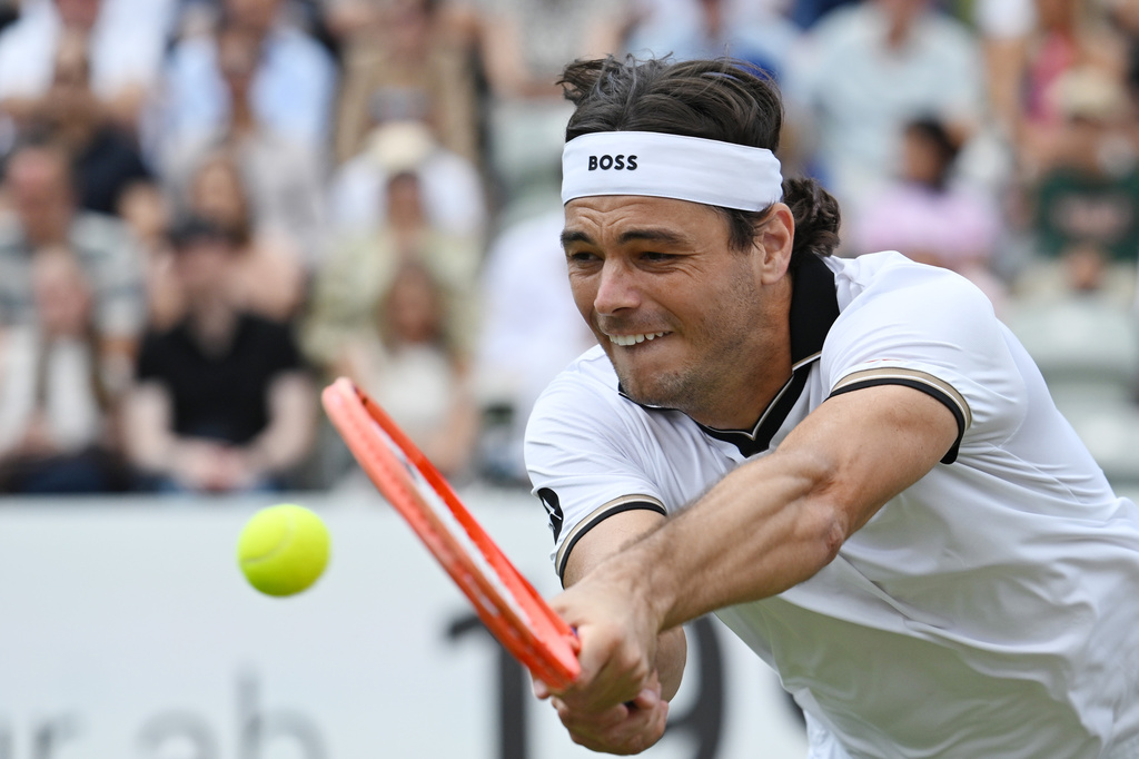 United States' Taylor Fritz returns the ball to United States' Ben Shelton during their Stuttgart Open tennis final match in Stuttgart, Germany, Sunday, June 14, 2026. (Marijan Murat/dpa via AP)