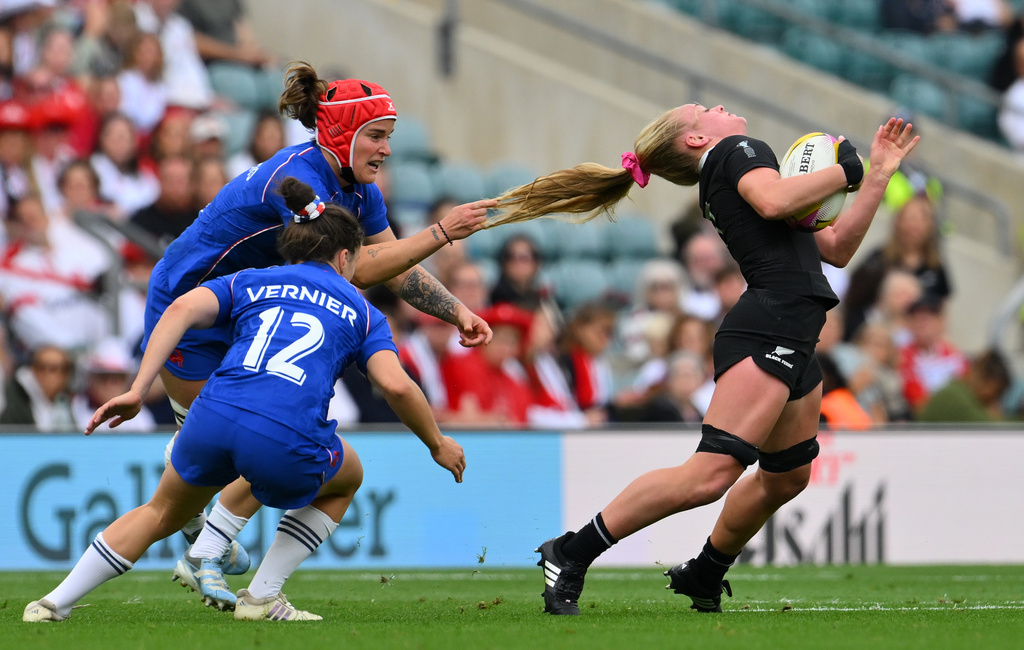 New Zealand's Jorja Miller gets her hair pulled by Charlotte Escudero of France during the Women's Rugby World Cup bronze match between New Zealand and France at the Allianz Stadium, Twickenham, London, Sept. 27, 2025. (AP Photo/Anthony Upton, File)