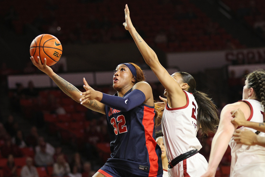 Mississippi forward Cotie McMahon (32) looks to score in front of Oklahoma guard Keziah Lofton, center, during the first half of an NCAA college basketball game Thursday, Jan. 8, 2026, in Norman, Okla. (AP Photo/Nate Billings)