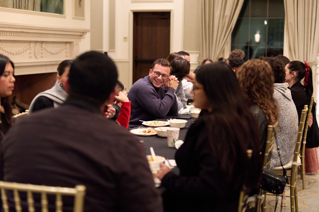 People gather after church service for the Young Adult Gathering Dinner and Discussion event at St. Sophia Greek Orthodox Cathedral Tuesday, Nov. 18, 2025, in Los Angeles. (AP Photo/Allison Dinner)