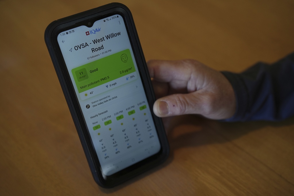 FILE - Mary Hess displays air quality data on the IQAir app on her phone, April 8, 2025, in Dale, Ind. (AP Photo/Joshua A. Bickel, File)