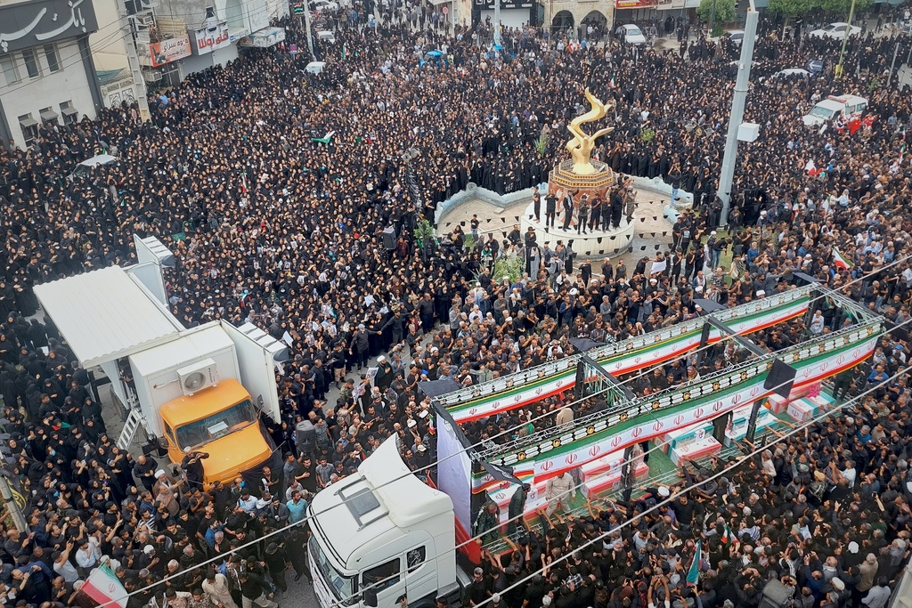 Residents and officials attend the funeral of people killed in what Iranian officials said was an Israeli-U.S. strike Feb. 28 on a girls' elementary school in Minab, Iran, Tuesday, March 3, 2026. (Abbas Zakeri/Mehr News Agency via AP)