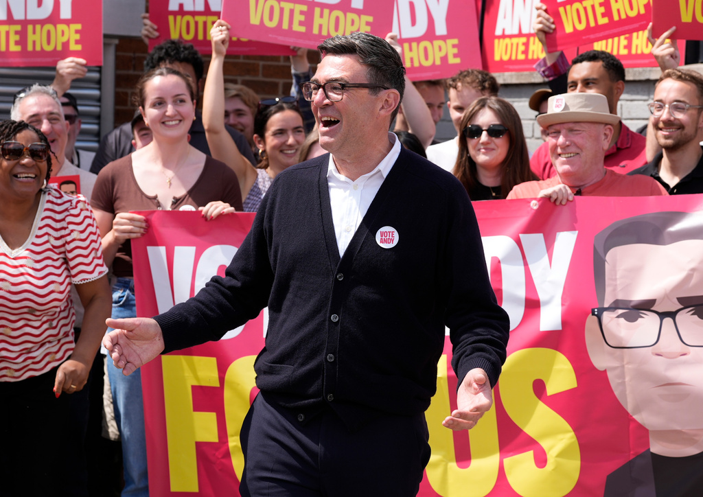 FILE - Labour candidate Andy Burnham gestures, surrounded by supporters at the Stubshaw Cross Community and Sports Club as voting is underway in the Makerfield by-election, in Ashton-in-Makerfield, England, Thursday, June 18, 2026. (Peter Byrne/PA via AP, file)