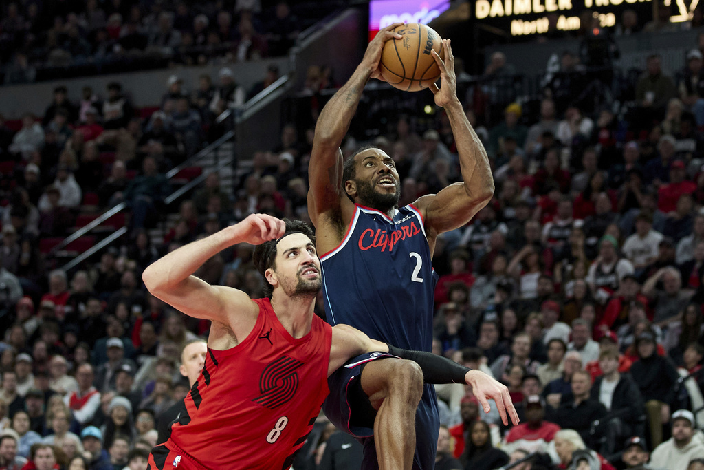 Los Angeles Clippers forward Kawhi Leonard (2) shoots over Portland Trail Blazers forward Deni Avdija (8) during the second half of an NBA basketball game in Portland, Ore., Friday, Dec. 26, 2025. (AP Photo/Craig Mitchelldyer)