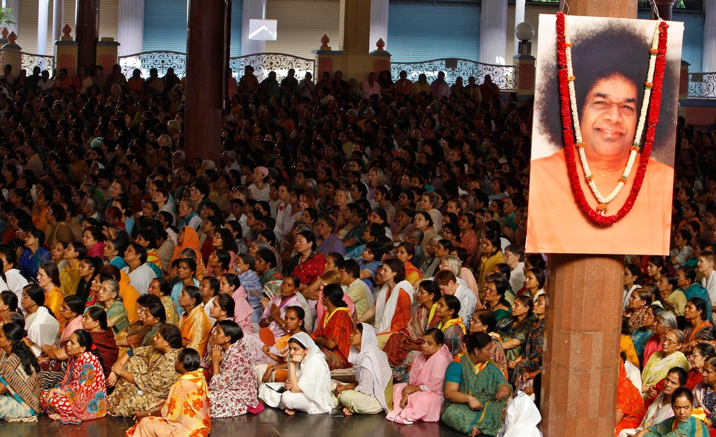 FILE - Devotees attend the last rites ceremony of Indian religious leader Sathya Sai Baba at the Prasanthi Nilayam Ashram in Puttaparti, India, April 27, 2011. (AP Photo/Aijaz Rahi, File)