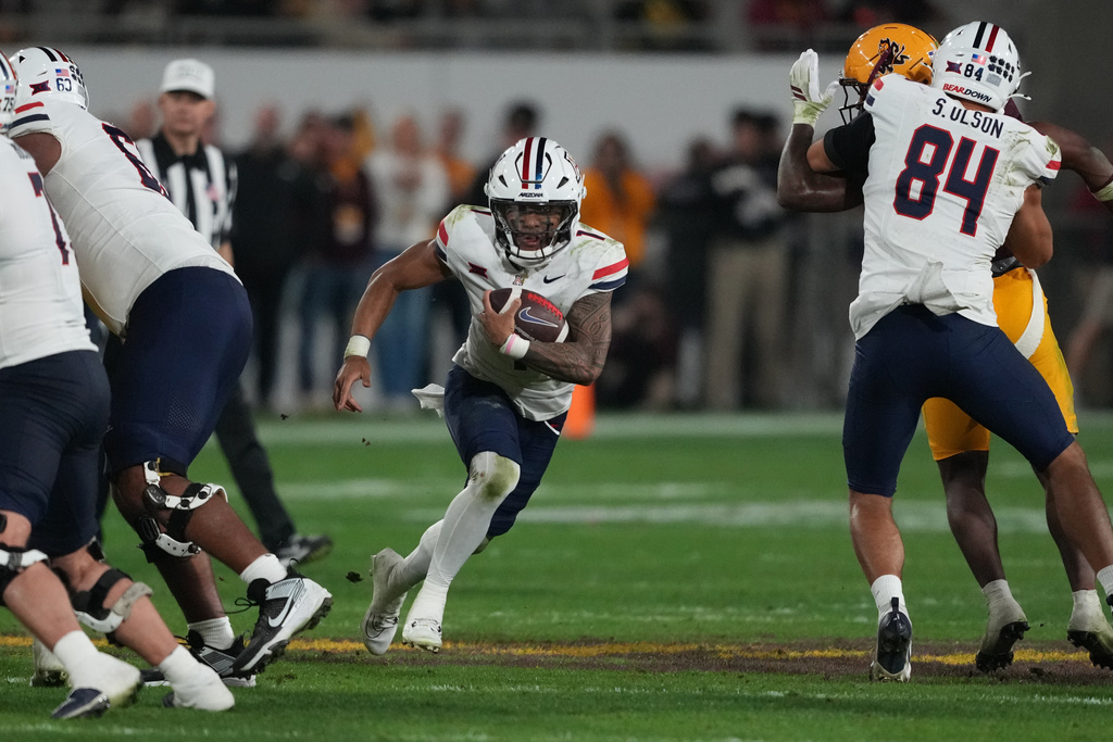 Arizona quarterback Noah Fifita (1) runs for a firstdown against Arizona State in the second half of an NCAA college football game, Friday, Nov. 28, 2025, in Tempe, Ariz. (AP Photo/Rick Scuteri)