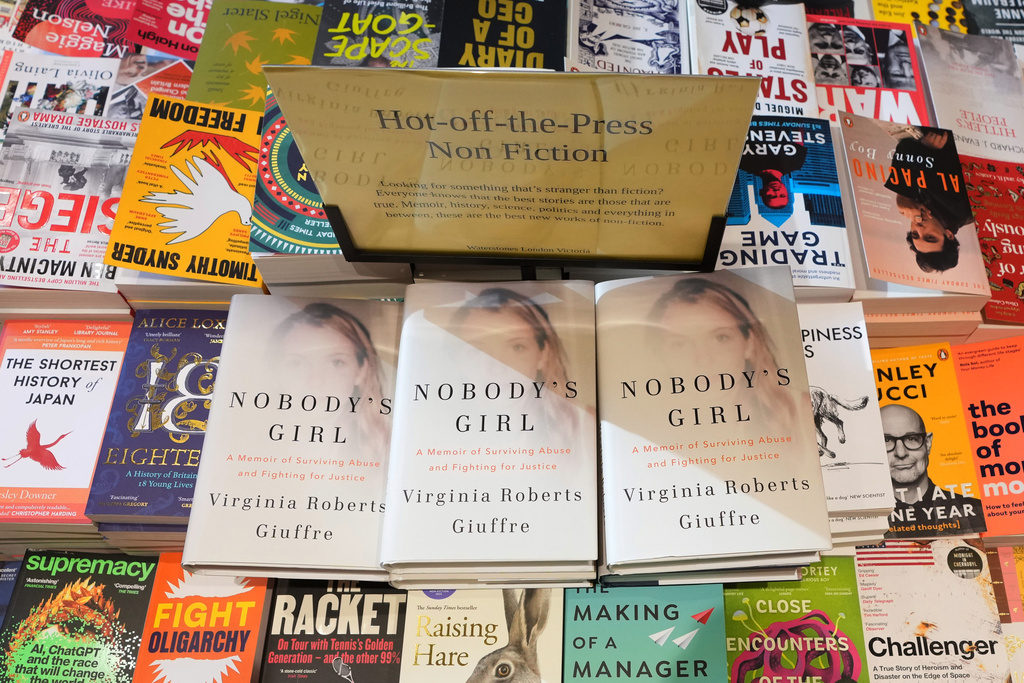 The memoir book of Virginia Giuffre, "Nobody's Girl" is seen amongst other books in a store and is up for sale in London, Tuesday, Oct. 21, 2025 six months after Giuffre died by suicide in April.(AP Photo/Kirsty Wigglesworth)