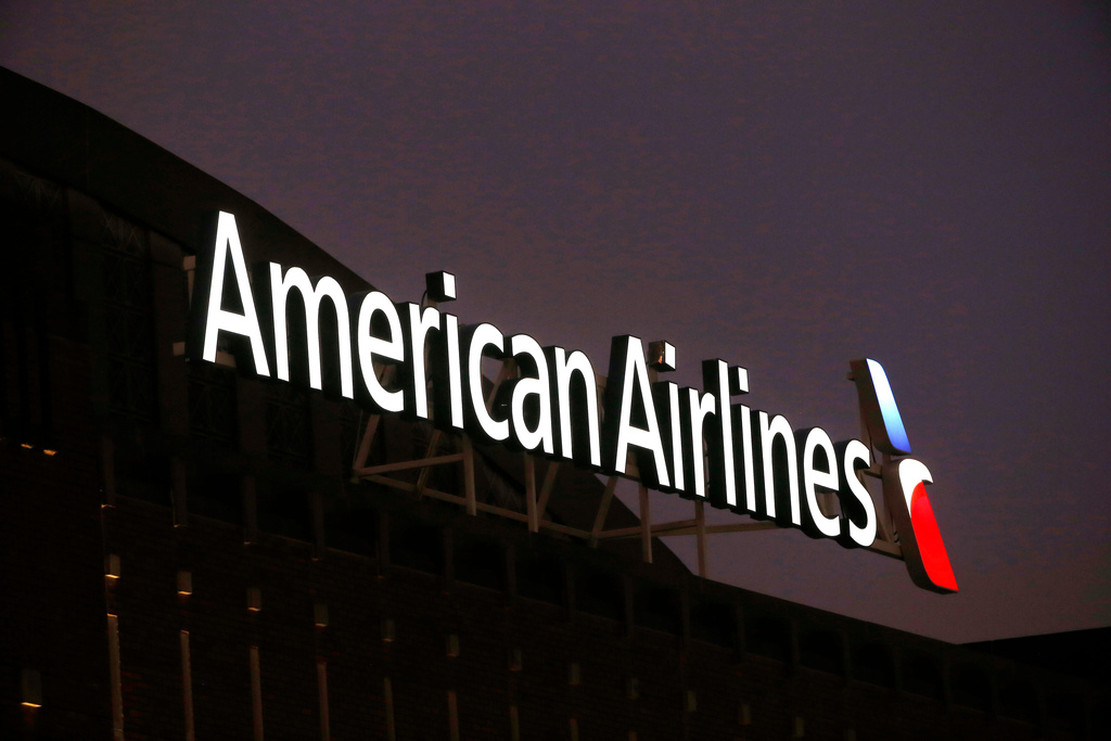FILE - The American Airlines logo is seen atop the American Airlines Center in Dallas, Dec. 19, 2017. Five flight attendants and one passenger went to a hospital after an American Airlines flight from Los Angeles made a hard landing on Maui, Saturday, Jan. 27, 2024. (AP Photo/Michael Ainsworth, File)