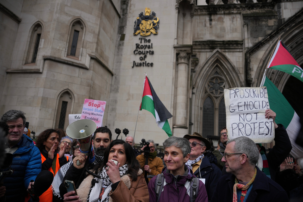Supporters of Palestine Action stage a protest outside the Royal Court of Justice in London, Friday, Feb. 13, 2026. (AP Photo/Kin Cheung)