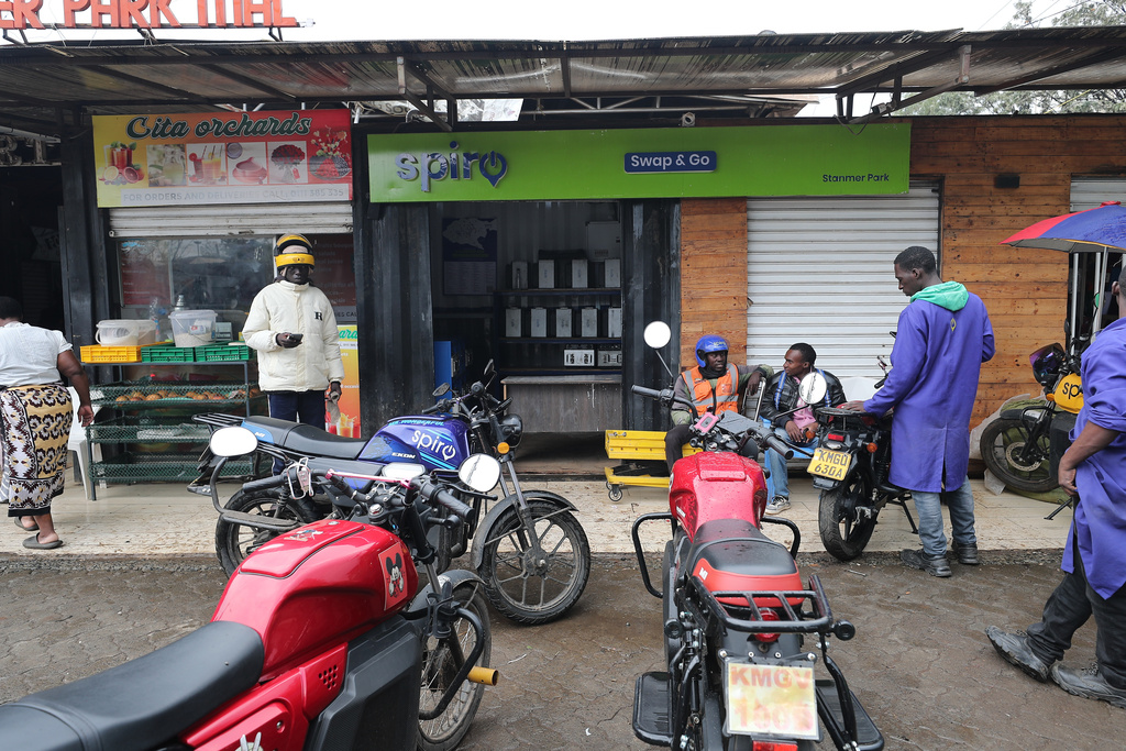 Riders swap batteries at an electric Spiro motorcycle charging station in Nairobi, Kenya, Tuesday, Feb. 24, 2026. (AP Photo/Henry Naminde)