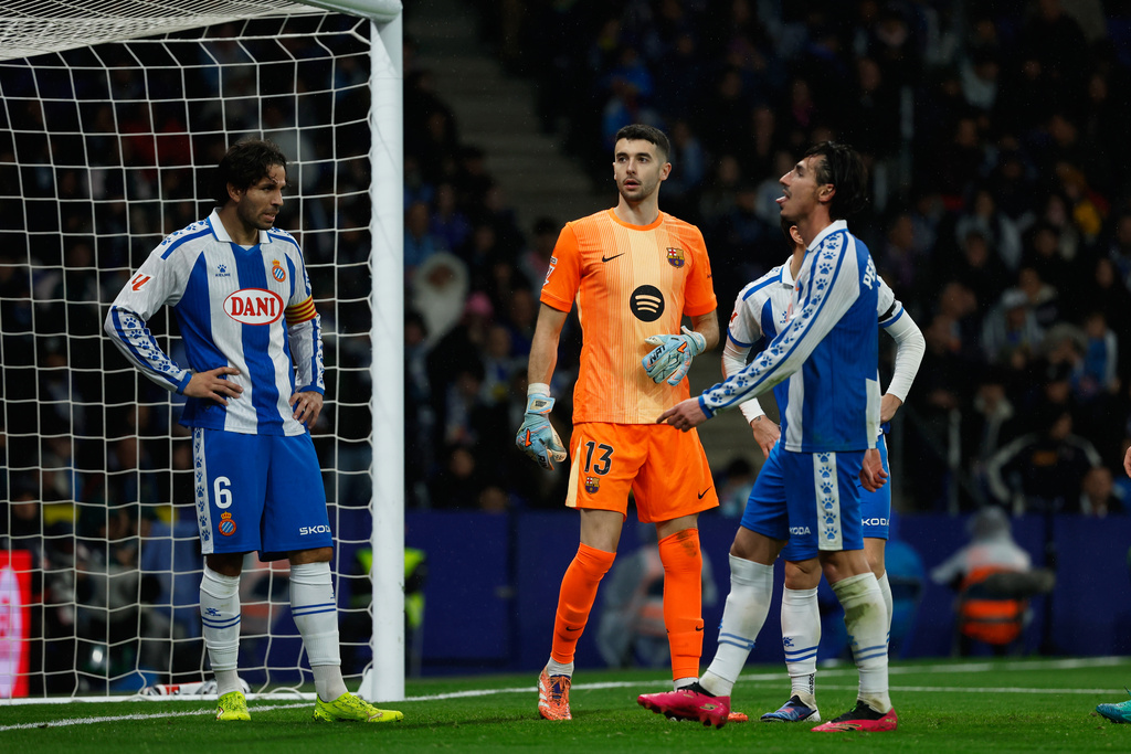 Espanyol's Pere Milla, right, reacts after missing a chance to score during the Spanish La Liga soccer match between RCD Espanyol and Barcelona in Barcelona, Spain, Saturday, Jan. 3, 2026. (AP Photo/Joan Monfort)
