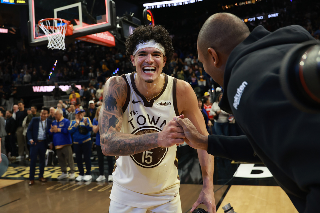 Golden State Warriors forward Gui Santos (15) celebrates with teammate Al Horford, right, after an NBA basketball game against the Brooklyn Nets in San Francisco, Wednesday, March 25, 2026. (AP Photo/Jed Jacobsohn)