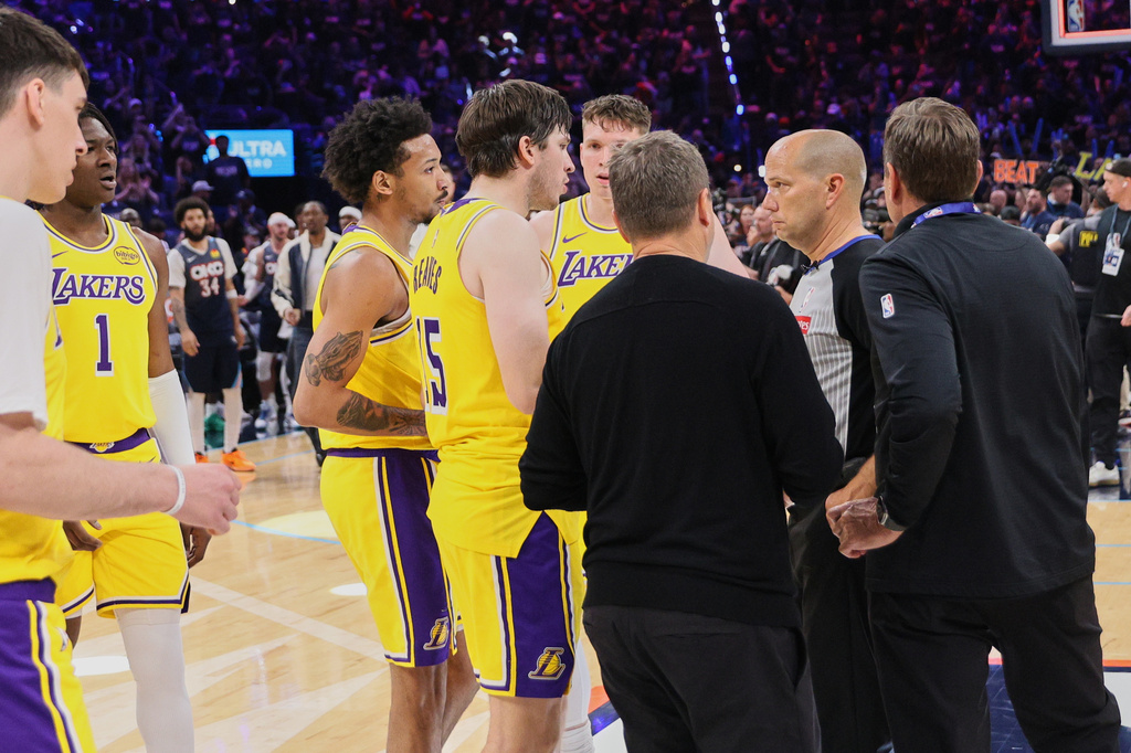 Los Angeles Lakers' Austin Reaves (15) and other Lakers players talk with referee John Goble, second from right, after the team's loss in Game 2 in a second-round NBA basketball playoffs series against the Oklahoma City Thunder Thursday, May 7, 2026, in Oklahoma City. (AP Photo/Nate Billings)