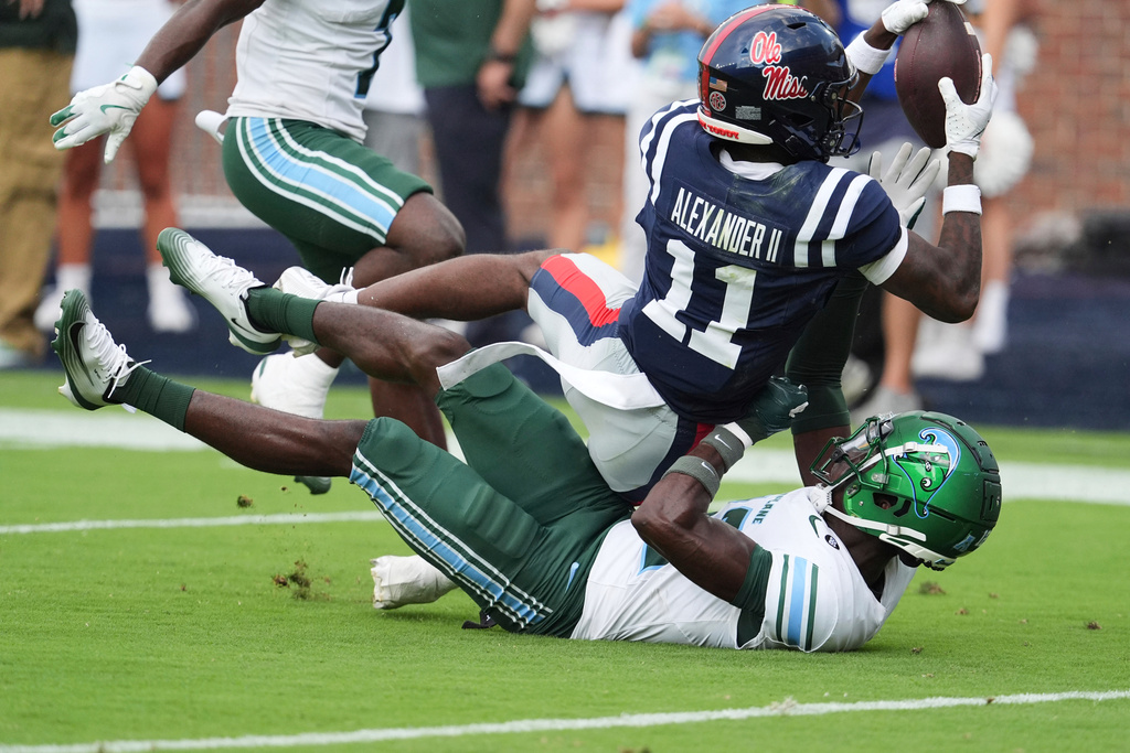 Mississippi wide receiver Deuce Alexander (11) pulls in a 33-yard touchdown pass while covered by a Tulane defender during the second half of an NCAA college football game in Oxford, Miss., Saturday, Sept. 20, 2025. (AP Photo/Rogelio V. Solis)