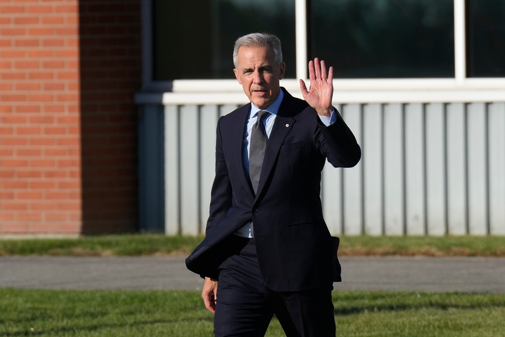 Canada Prime Minister Mark Carney walks to a government plane in Ottawa, Ontario, Monday Oct. 6, 2025. (Adrian Wyld/The Canadian Press via AP)
