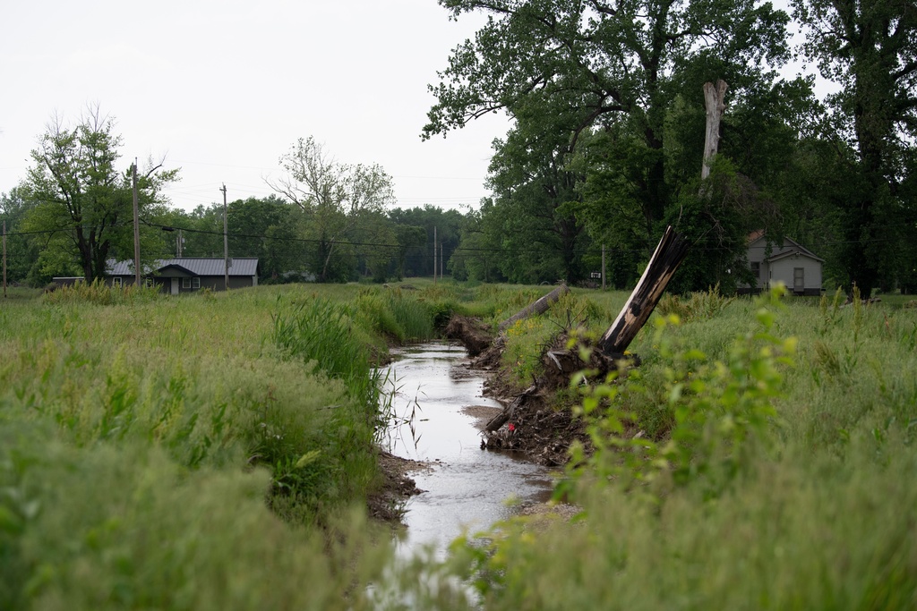Water flows near homes in flood-prone Cahokia Heights, Ill., May 15, 2025. (AP Photo/Michael Phillis)