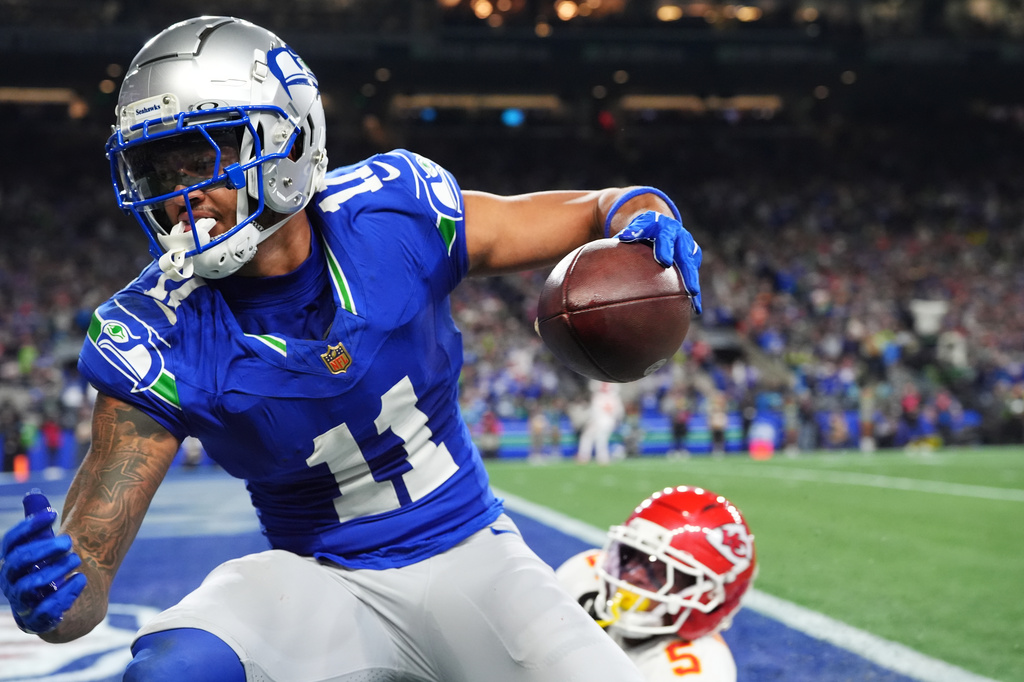 Seattle Seahawks wide receiver Jaxon Smith-Njigba (11) reacts after a catch for a touchdown in front of Kansas City Chiefs cornerback Mansoor Delane (5) during the first half of an NFL football game in Seattle, Sunday, Oct. 25, 2026. (AP Photo/Lindsey Wasson)