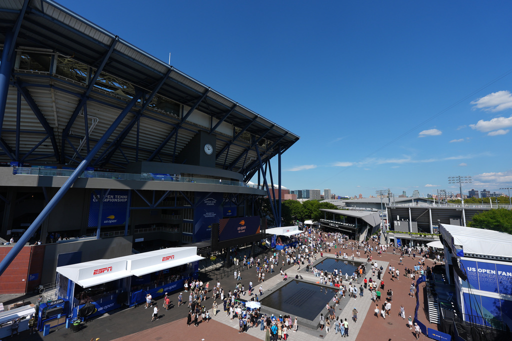 Fans walk outside Arthur Ashe Stadium at the U.S. Open tennis championships Wednesday, Aug. 26, 2026, in New York. (AP Photo/Frank Franklin II)