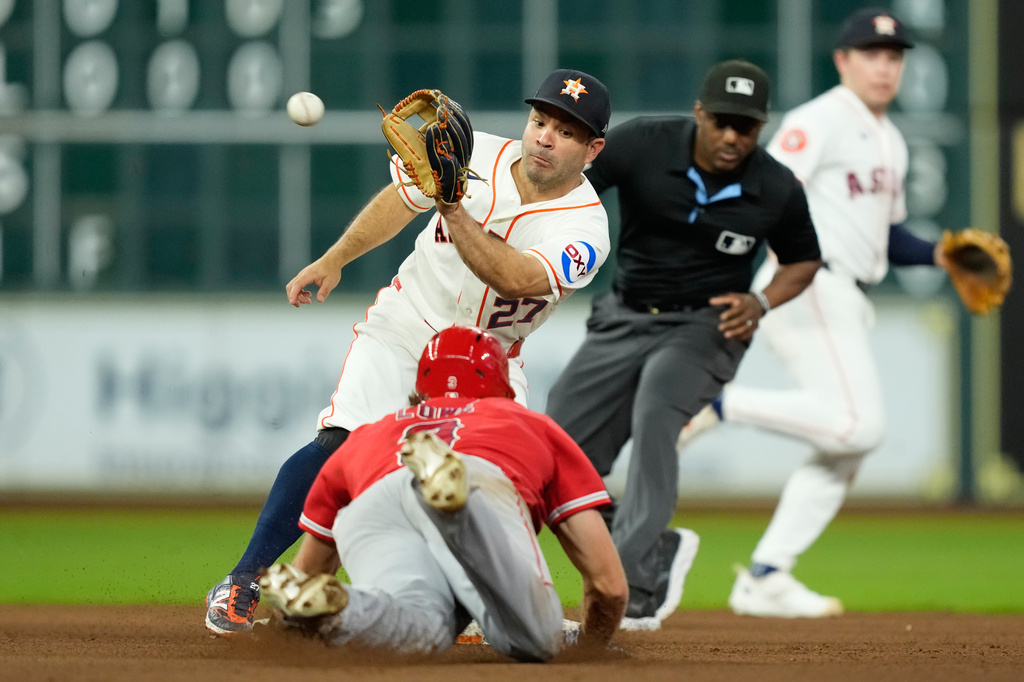 Houston Astros second baseman Jose Altuve (27) catches the throw from catcher Christian Vázquez before tagging out Los Angeles Angels' Josh Lowe as he tries to steal second base during the sixth inning of a baseball game Wednesday, Aug. 19, 2026, in Houston. (AP Photo/David J. Phillip)