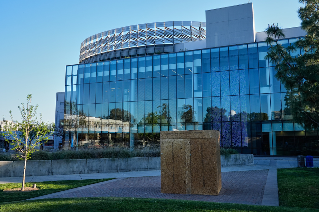 Plywood panels encapsulate a statue of César Chavez at California State University, Fresno in Fresno, Calif., Wednesday, March 18, 2026. (AP Photo/Godofredo A. Vásquez)