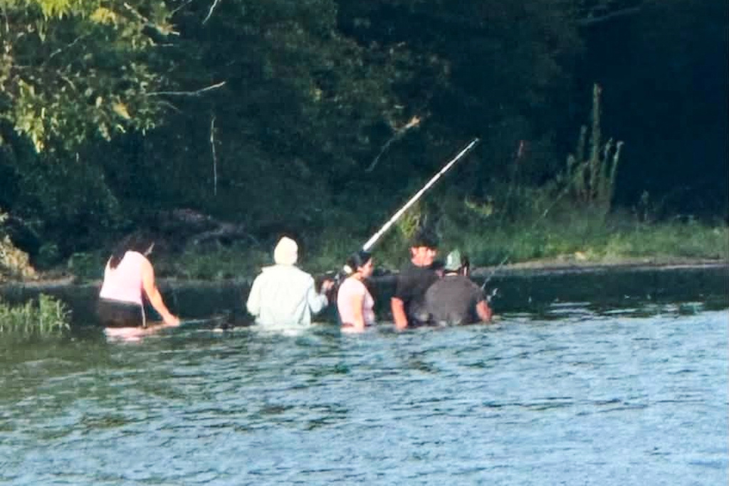 In this photo provided by Pastor Marcus L. Martin, a group of people he believes were those who died in a recent drowning accident, are shown fishing along the Scioto river in Powell, Ohio, Sunday, July 19, 2026. (Pastor Marcus L. Martin via AP)