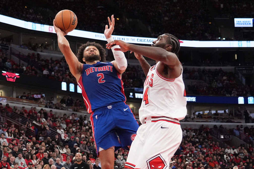 Detroit Pistons guard Cade Cunningham, left, shoots against Chicago Bulls forward Patrick Williams during the first half of an NBA basketball game in Chicago, Wednesday, Oct. 22, 2025. (AP Photo/Nam Y. Huh)