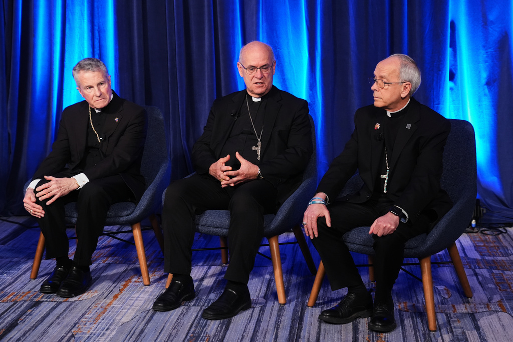 From left, Archbishop Timothy Broglio, Bishop Kevin C. Rhoades and Bishop Mark J. Seitz speak during a press conference at the United States Conference of Catholic Bishops plenary assembly in Baltimore, Tuesday, Nov. 11, 2025. (AP Photo/Stephanie Scarbrough)