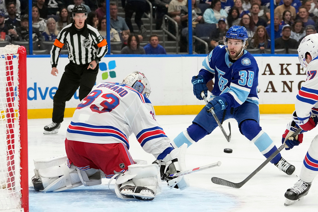 Tampa Bay Lightning left wing Brandon Hagel (38) takes a shot on New York Rangers goaltender Dylan Garand (33) during the second period of an NHL hockey game Wednesday, April 15, 2026, in Tampa, Fla. (AP Photo/Chris O'Meara)