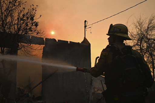A firefighters waters down a home after the Eaton Fire burns in Altadena, Calif., Thursday, Jan. 9, 2025. (AP Photo/Nic Coury) A firefighters waters down a home after the Eaton Fire burns in Altadena, Calif., Thursday, Jan. 9, 2025. (AP Photo/Nic Coury)