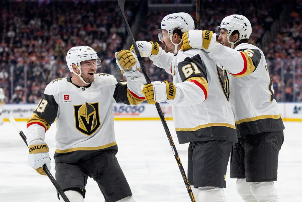 Vegas Golden Knights' Ivan Barbashev (49), Mark Stone (61) and Noah Hanifin (15) celebrate a goal against the Edmonton Oilers during the third period of an NHL hockey game in Edmonton, Alberta, on Saturday, April 4, 2026. (Jason Franson/The Canadian Press via AP)
