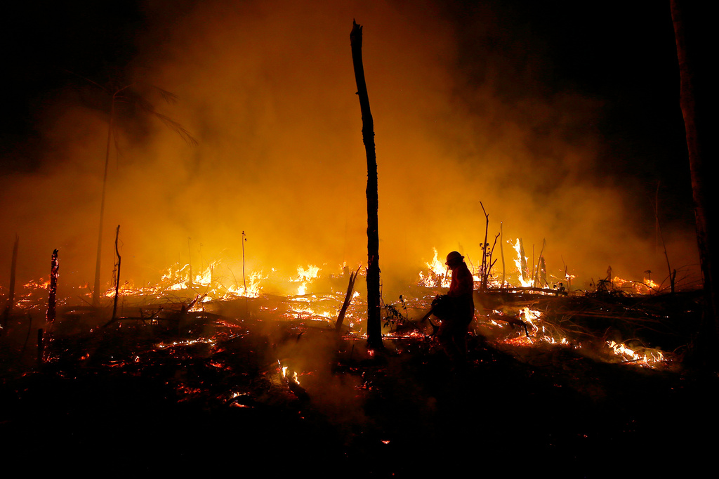 FILE - Firefighters work to put out a blaze in the Amazon forest during a drought and high temperatures in the rural municipality of Careiro Castanho, Amazonas state, Brazil, Oct. 21, 2023. (AP Photo/Edmar Barros, File)