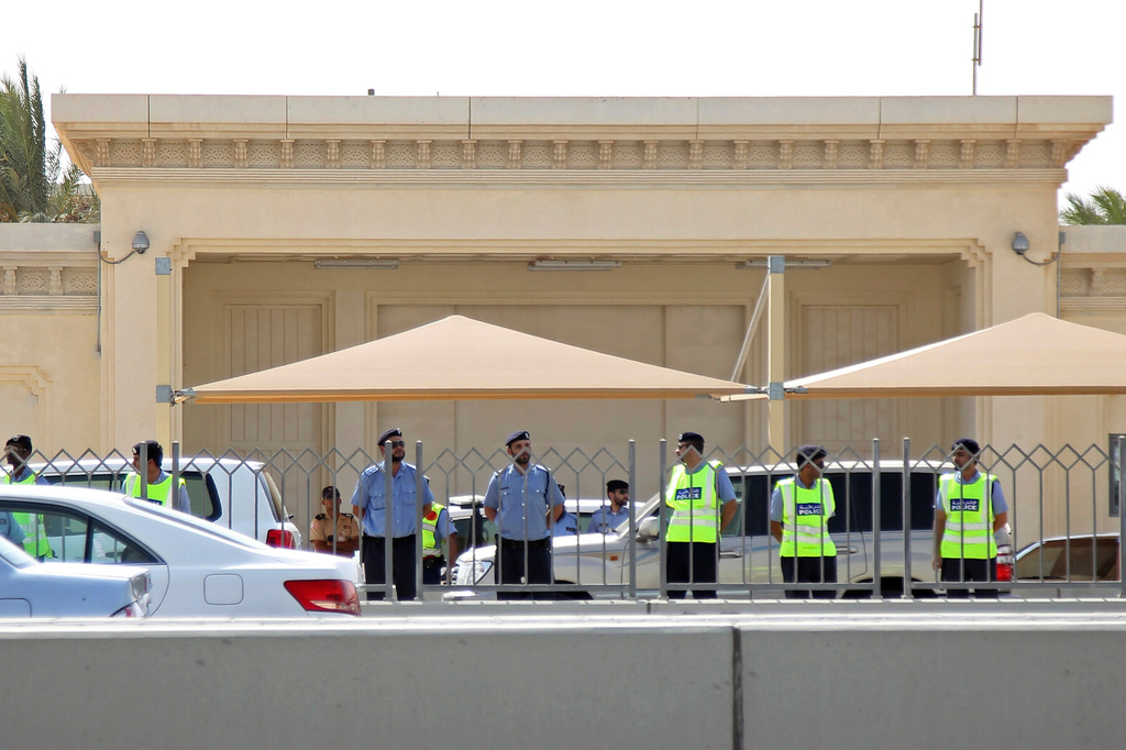 FILE - Qatar's police surround the U.S. embassy during a demonstration in Doha, Qatar, Sept. 14, 2012. (AP Photo/Osama Faisal, File)