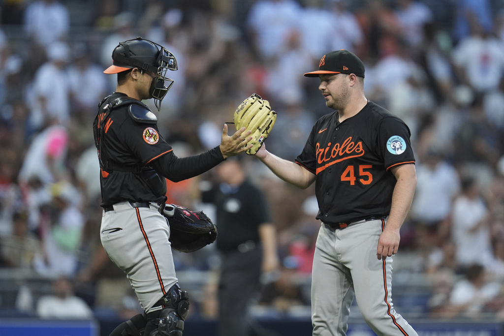 Baltimore Orioles relief pitcher Keegan Akin (45) celebrates with catcher Alex Jackson after the Orioles defeated the San Diego Padres 4-3 in a baseball game Monday, Sept. 1, 2025, in San Diego. (AP Photo/Gregory Bull)