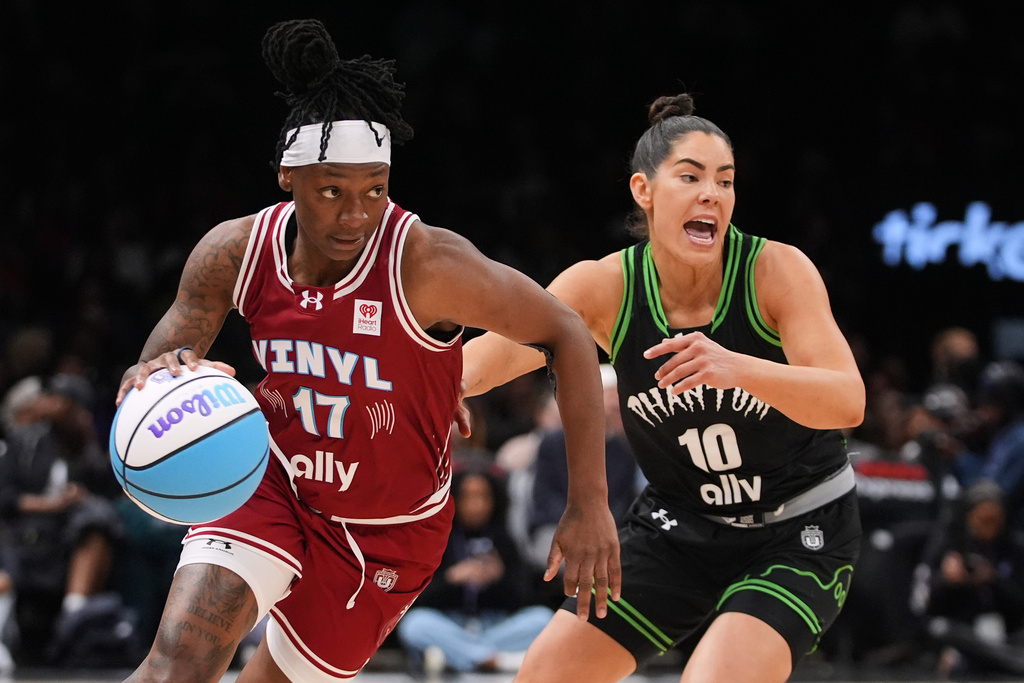 Vinyl BC guard Erica Wheeler (17) drives past Phantom BC guard Kelsey Plum (10) during the first half of a semifinal in their Unrivaled 3-on-3 basketball game, Monday, March 2, 2026, in New York. (AP Photo/Frank Franklin II)