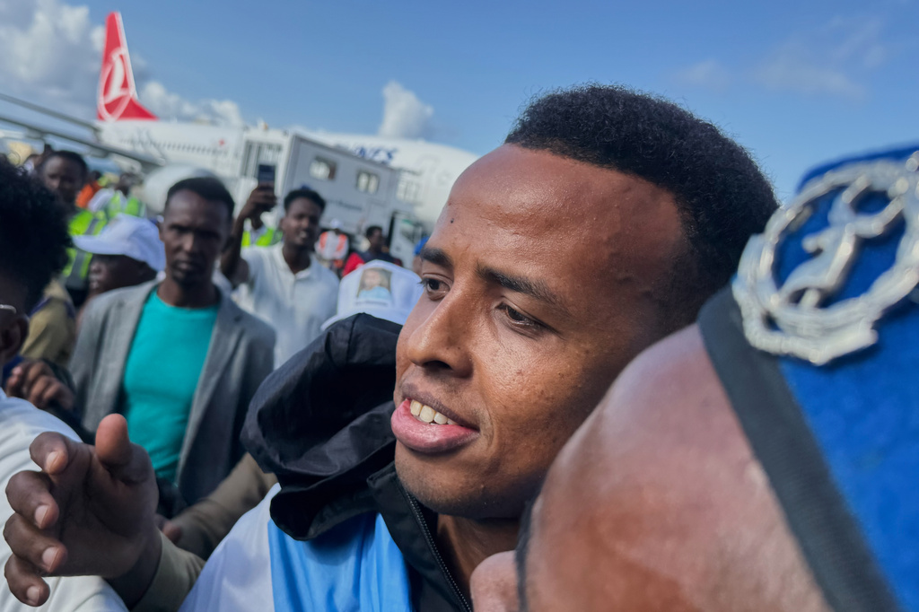 Referee Omar Artan, who was denied entry to the United States, is welcomed by supporters upon his arrival in Mogadishu, Somalia, Wednesday, June 10, 2026. (AP Photo/Farah Abdi Warsameh)