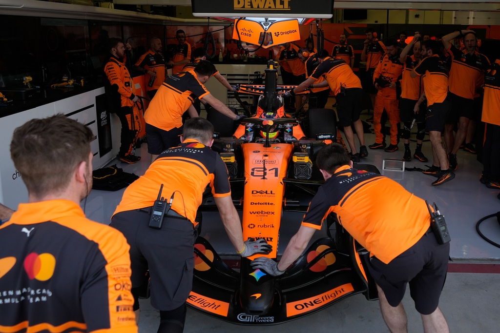 McLaren driver Oscar Piastri of Australia gets pushed back into his garage on the third day of Formula One pre-season test at the Bahrain International Circuit in Sakhir, Bahrain, Friday, Feb. 13, 2026. (AP Photo/Altaf Qadri)