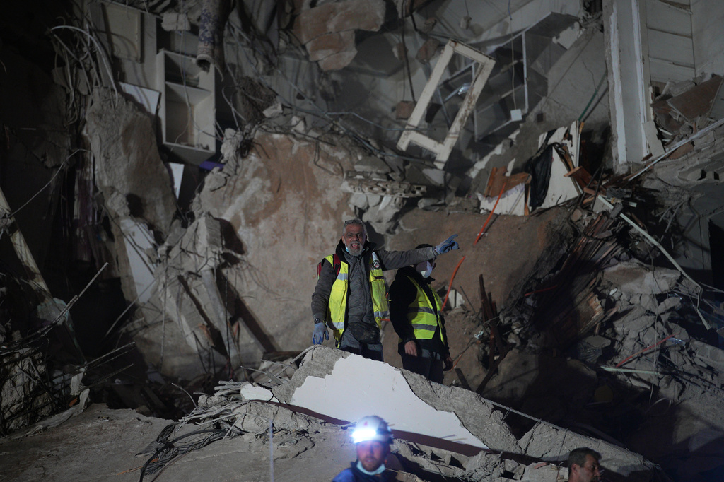 A rescuer stands on the rubble of a destroyed building that was hit in an Israeli airstrike in central Beirut, Lebanon, Wednesday, April 8, 2026. (AP Photo/Emilio Morenatti)