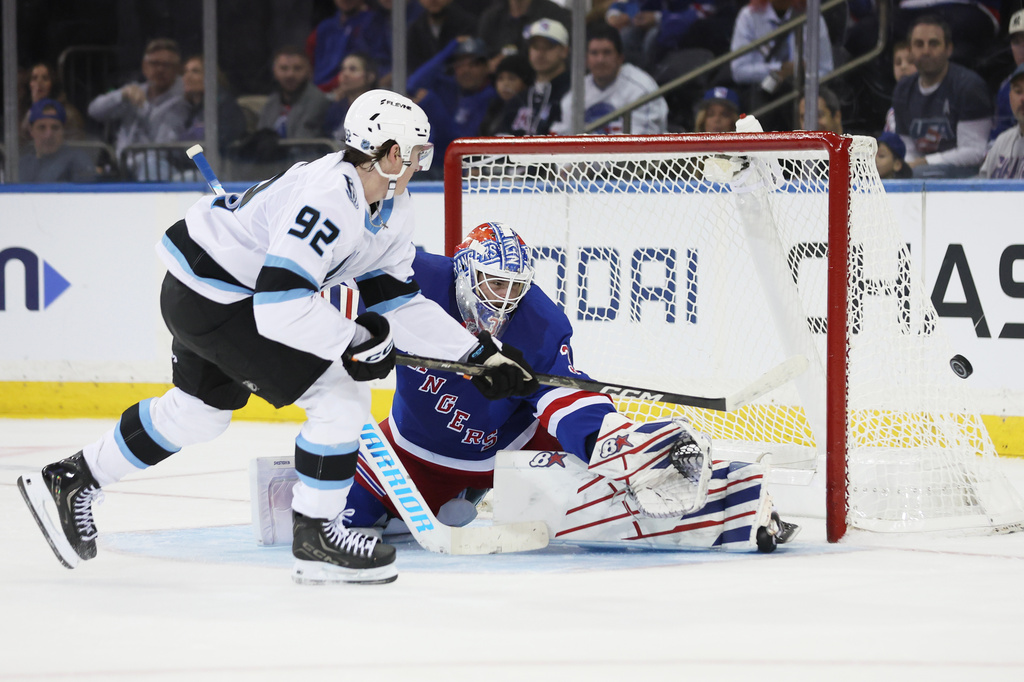 New York Rangers goaltender Igor Shesterkin, right, makes a save against a shot-attempt by Utah Mammoth center Logan Cooley (92) during the second period of an NHL hockey game, Sunday, Oct. 4, 2026, in New York. (AP Photo/Heather Khalifa)