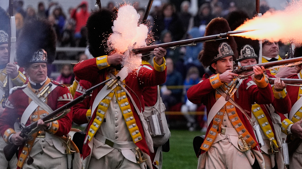 British red coat soldiers fire on the colonial minute men during the historic re-enactment of the Battle of Lexington, Saturday, April 18, 2026, in Lexington, Mass. (AP Photo/Charles Krupa)