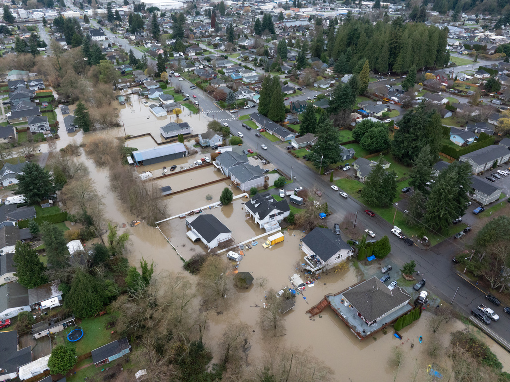 Portions of a neighborhood are flooded on Friday, Dec. 12, 2025, in Burlington, Wash. (AP Photo/Stephen Brashear)