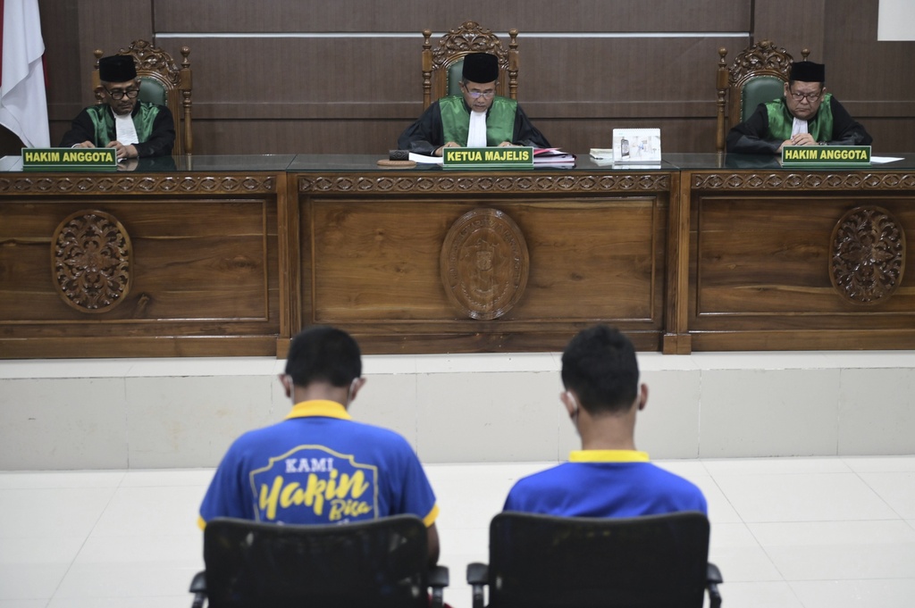 Chief Judge Rokhmadi, center, reads his verdict during the sentencing hearing for two men accused of having gay sex, at the Sharia Court in Banda Aceh, Indonesia, Monday, Aug. 11, 2025. (AP Photo/Reza Saifullah)