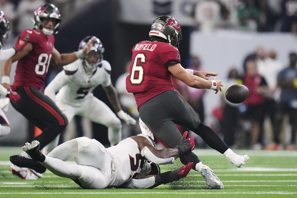 Tampa Bay Buccaneers quarterback Baker Mayfield (6) is stripped of the ball in the second half of an NFL football game against the Houston Texans Monday, Sept. 15, 2025, in Houston, Texas. (AP Photo/Eric Gay)