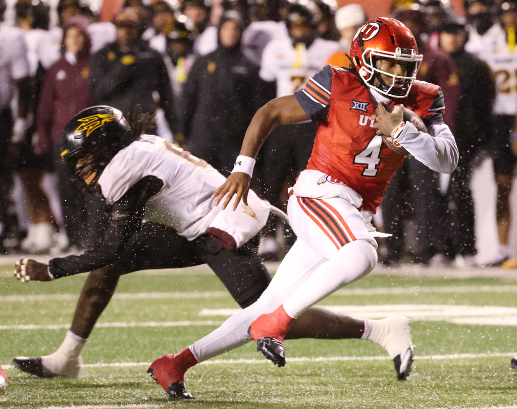 Utah quarterback Devon Dampier (4) runs for a touchdown against Arizona during the first half of an NCAA college football game Saturday, Oct. 11, 2025, in Salt Lake City. (AP Photo/Jeffrey D. Allred)