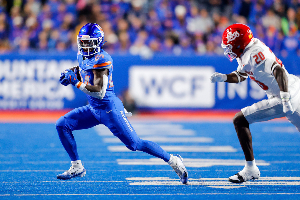 Boise State running back Dylan Riley (24) runs away from New Mexico linebacker Ky'Won McCray (20) after a reception in the first half of an NCAA college football game, Saturday, Oct. 11, 2025, in Boise, Idaho. (AP Photo/Steve Conner)