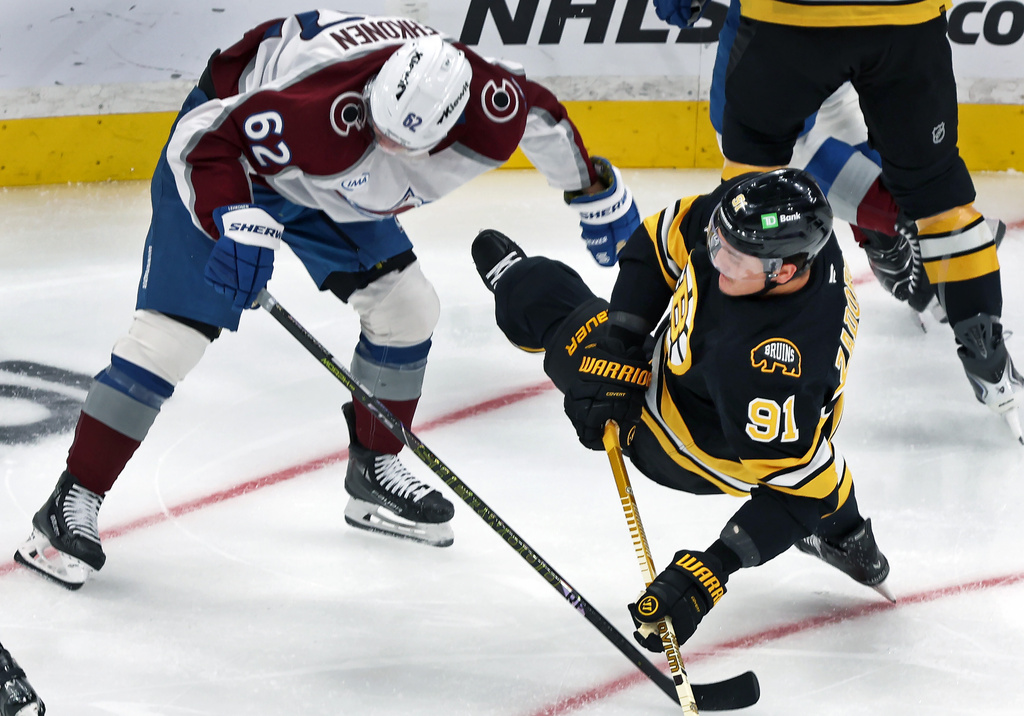 Boston Bruins defenseman Nikita Zadorov, right, hits the ice during a first period collision with Colorado Avalanche forward Artturi Lehkonen during an NHL hockey game, Saturday, Oct. 25, 2025, in Boston. (AP Photo/Jim Davis)