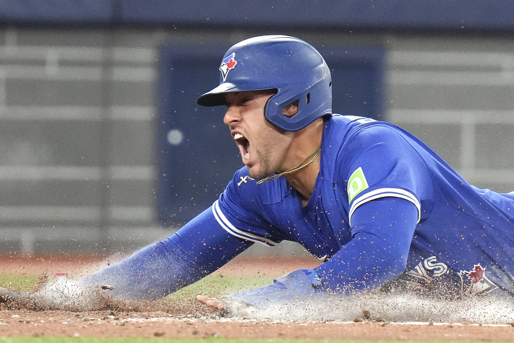 Toronto Blue Jays' George Springer (4) reacts after scoring a run against the Minnesota Twins during third inning MLB baseball action in Toronto on Wednesday, August 27, 2025. (Chris Young/The Canadian Press via AP)
